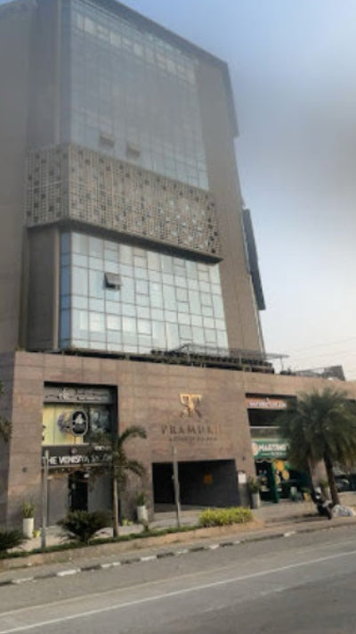 Tall building with a logo on the street in an urban setting